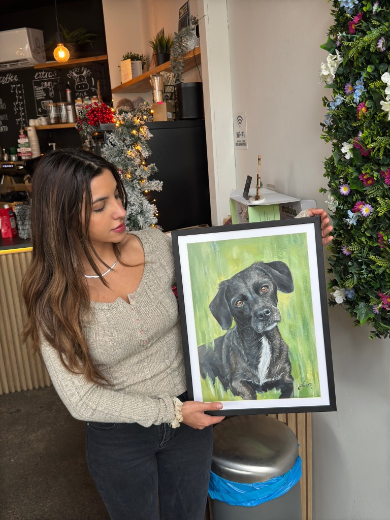 Katerina holding artwork